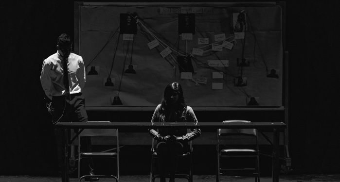 black and white photo of investigators in front of a crime board.jpg.optimal