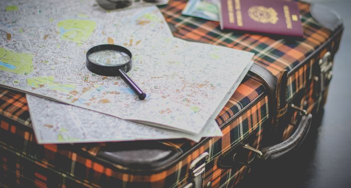 image of a suitcase with magnifying glass and map.jpg.optimal