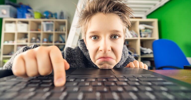 teenage boy using laptop